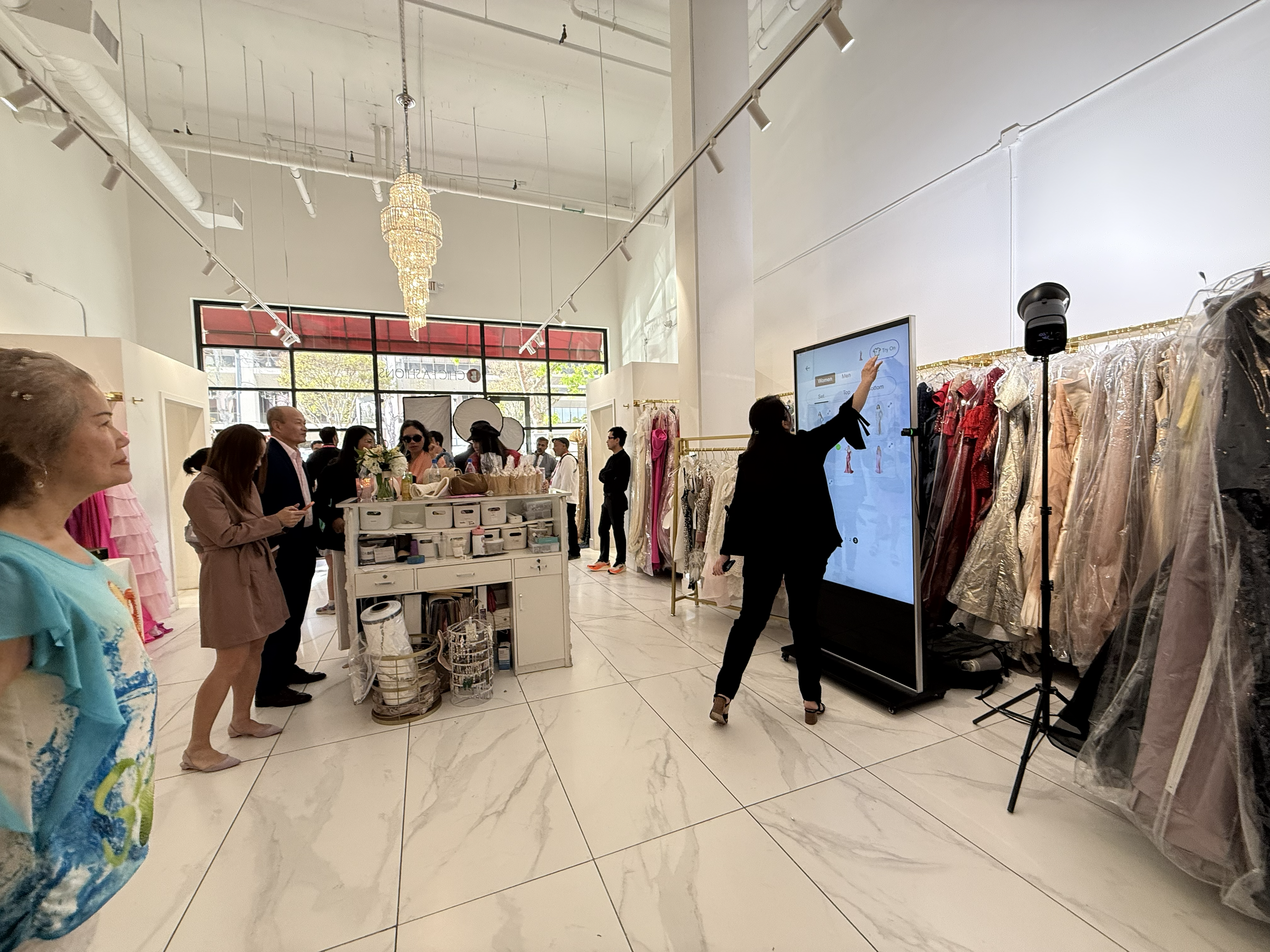 Shopper using New Port AI fitting mirror for virtual dress try-on at B Chic boutique